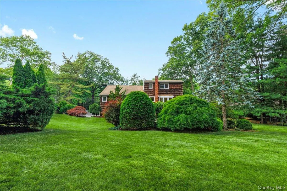 Expansive lawn featuring mature trees and established landscaping Expansive lawn featuring mature trees and established landscaping