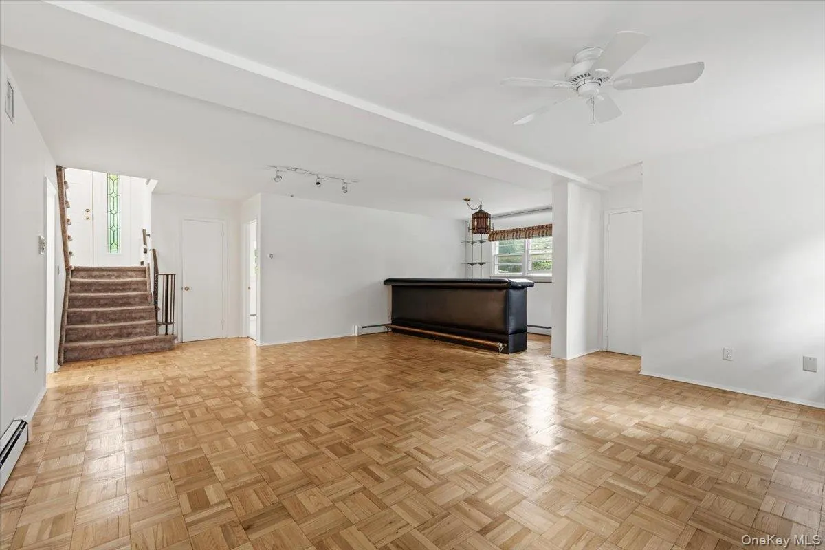 Large family room with natural light flowing through, wood floors, wood burning fireplace and bar area. Large family room with natural light flowing through, wood floors, wood burning fireplace and bar area.