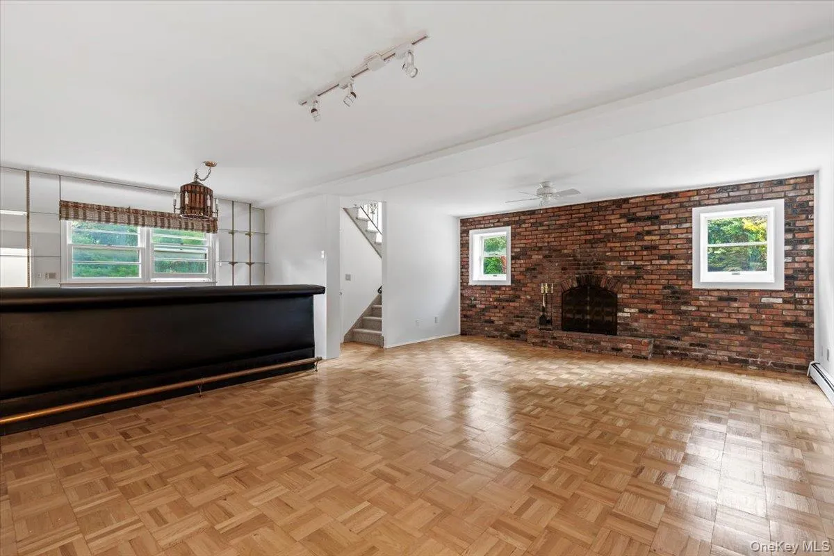 Spacious family room features a brick fireplace, built-in bar area, and tons of rec space. Spacious family room features a brick fireplace, built-in bar area, and tons of rec space.