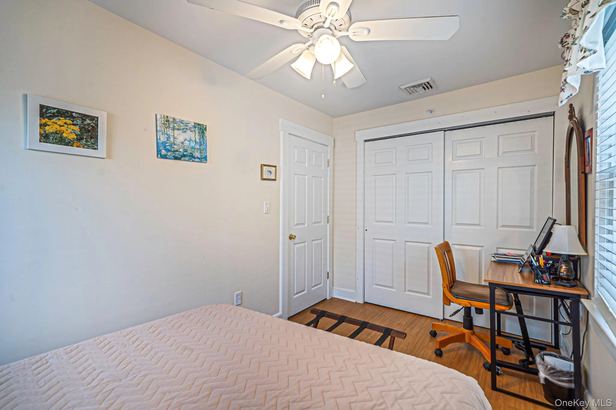 Inviting third-level bedroom filled with natural light and ample closet space Inviting third-level bedroom filled with natural light and ample closet space