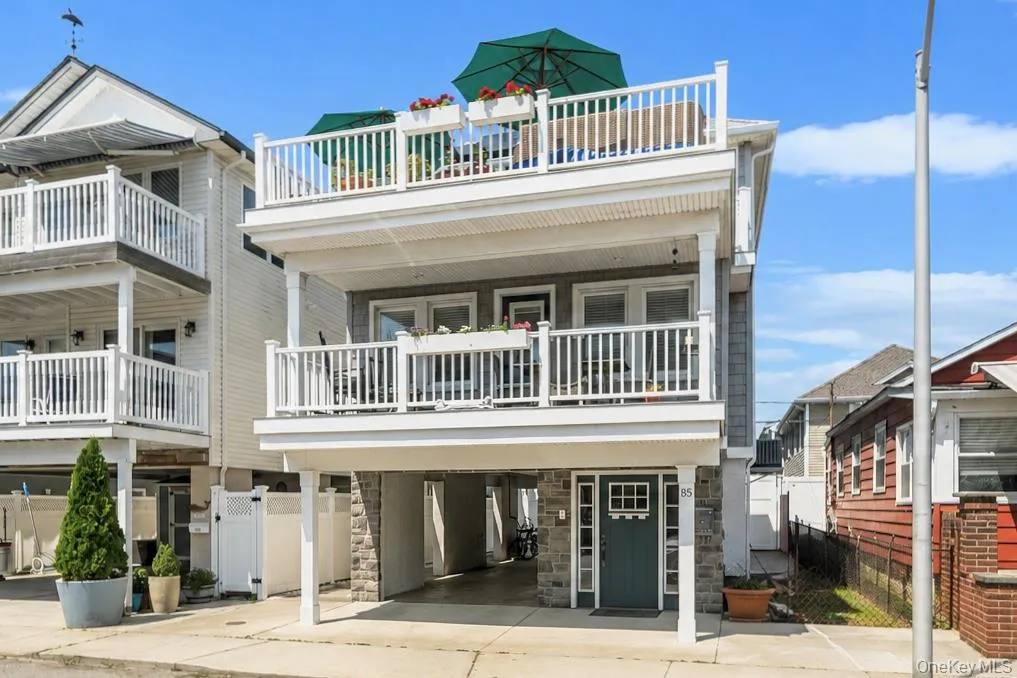 Inviting coastal exterior showcasing covered parking, spacious decks, and timeless curb appeal. Inviting coastal exterior showcasing covered parking, spacious decks, and timeless curb appeal.