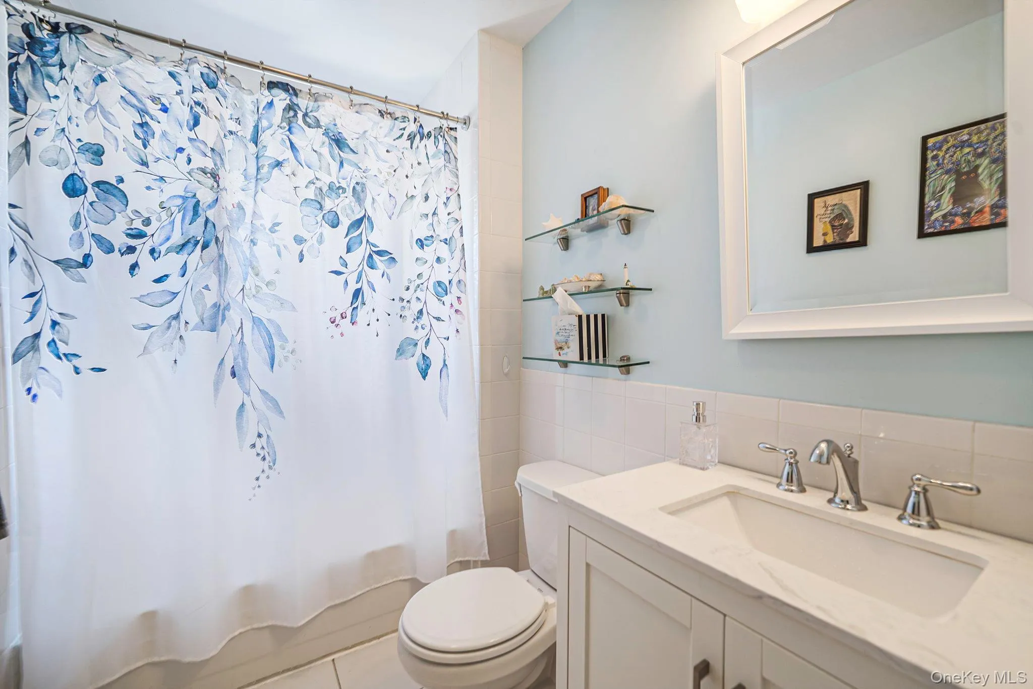Updated full bath featuring a modern vanity, tiled tub/shower, and bright coastalfinishes. Updated full bath featuring a modern vanity, tiled tub/shower, and bright coastalfinishes.