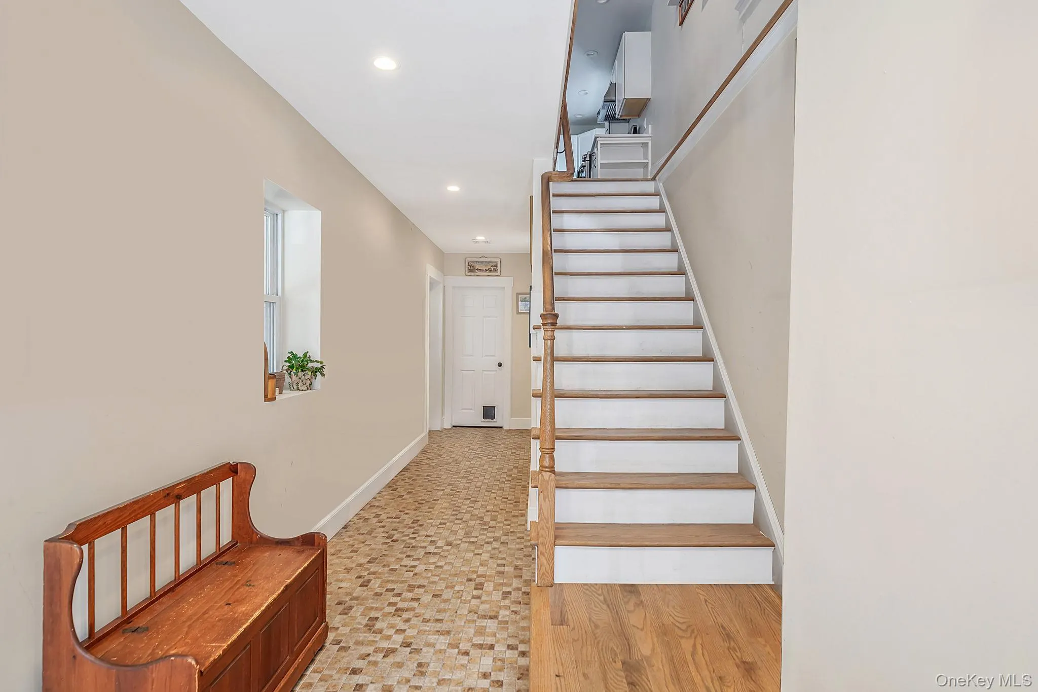 Bright entry hallway with hardwood staircase leading to the main living level. Bright entry hallway with hardwood staircase leading to the main living level.