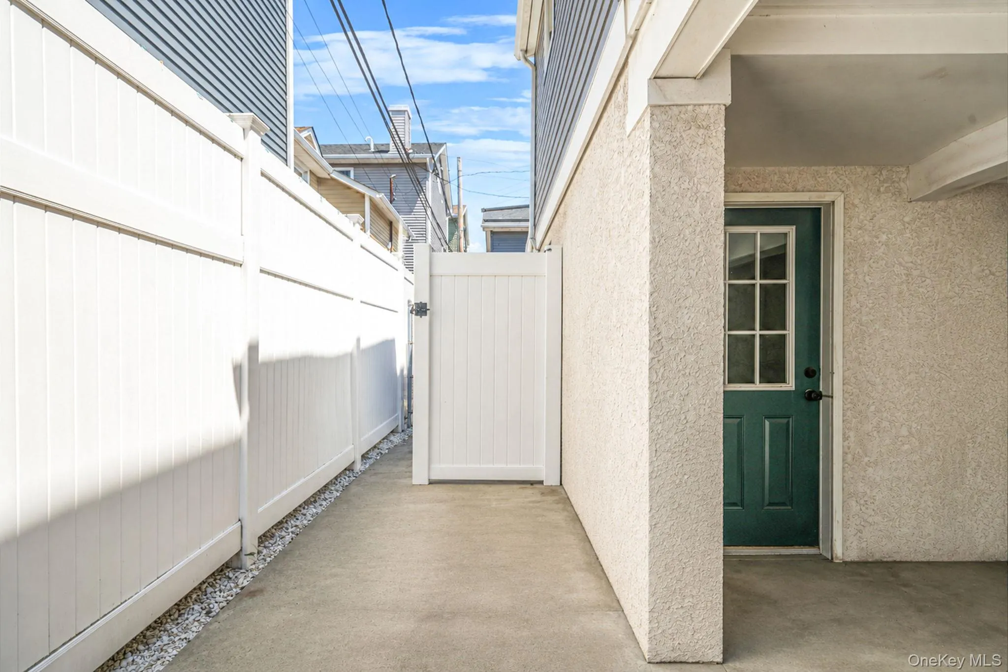 Private rear access leading to covered parking and outdoor shower. Private rear access leading to covered parking and outdoor shower.