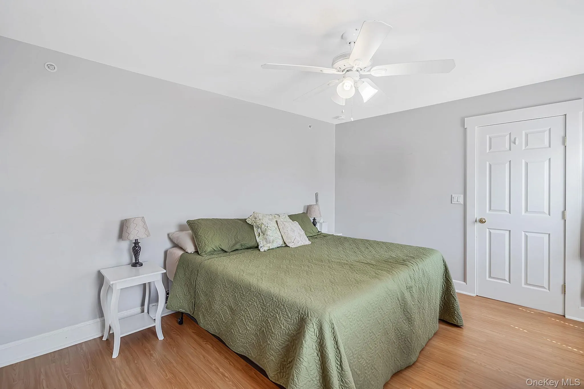 Spacious primary bedroom with abundant natural light. Hallway access to spacious entertaining deck Spacious primary bedroom with abundant natural light. Hallway access to spacious entertaining deck