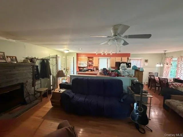Hardwood flooring, stone fireplace, ceiling fan, recessed lighting, wood cabinetry Hardwood flooring, stone fireplace, ceiling fan, recessed lighting, wood cabinetry