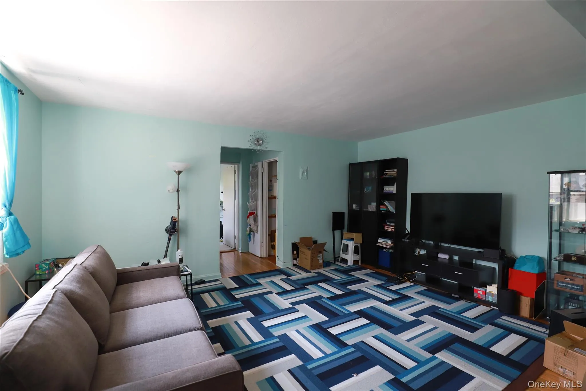 Living area featuring light blue wall paint and a light-colored ceiling Living area featuring light blue wall paint and a light-colored ceiling