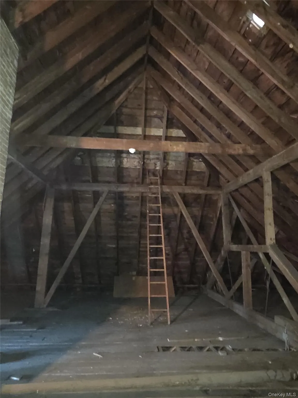 Exposed wood beam construction with a peaked roofline, offering significant overhead clearance Exposed wood beam construction with a peaked roofline, offering significant overhead clearance