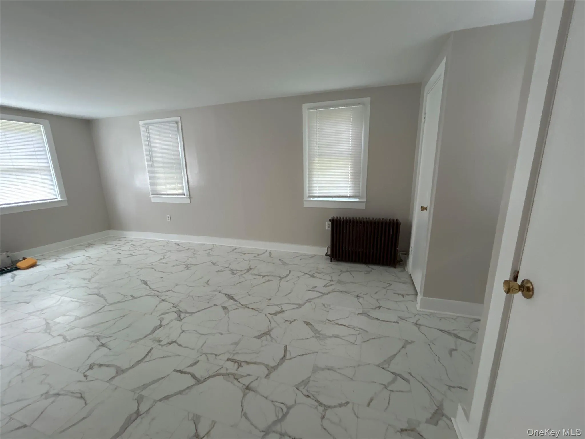 Light and Bright Living room with tile floor and two closets Light and Bright Living room with tile floor and two closets
