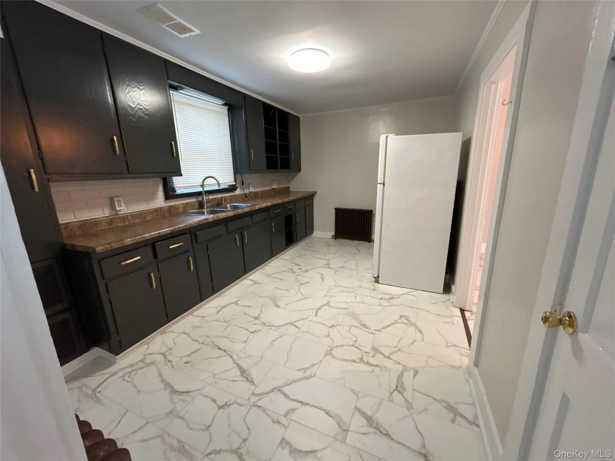 Galley kitchen with tile floor. This has outside entrance to the deck Galley kitchen with tile floor. This has outside entrance to the deck