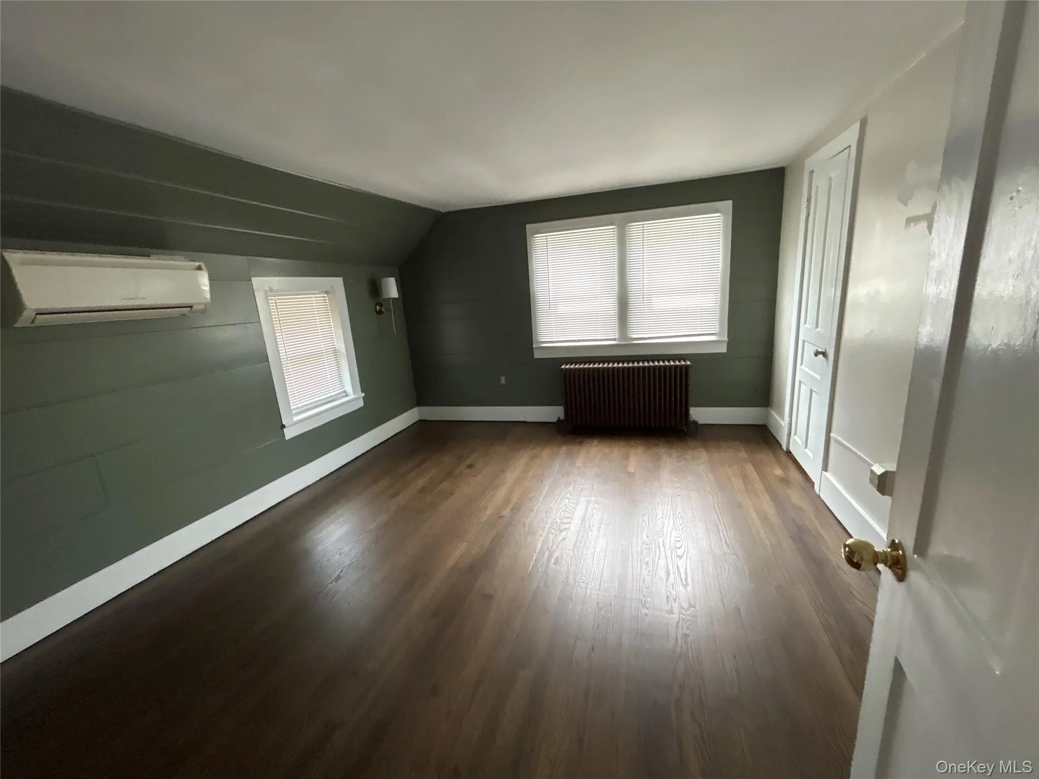 Second floor bedroom with wood floors and mini split Second floor bedroom with wood floors and mini split