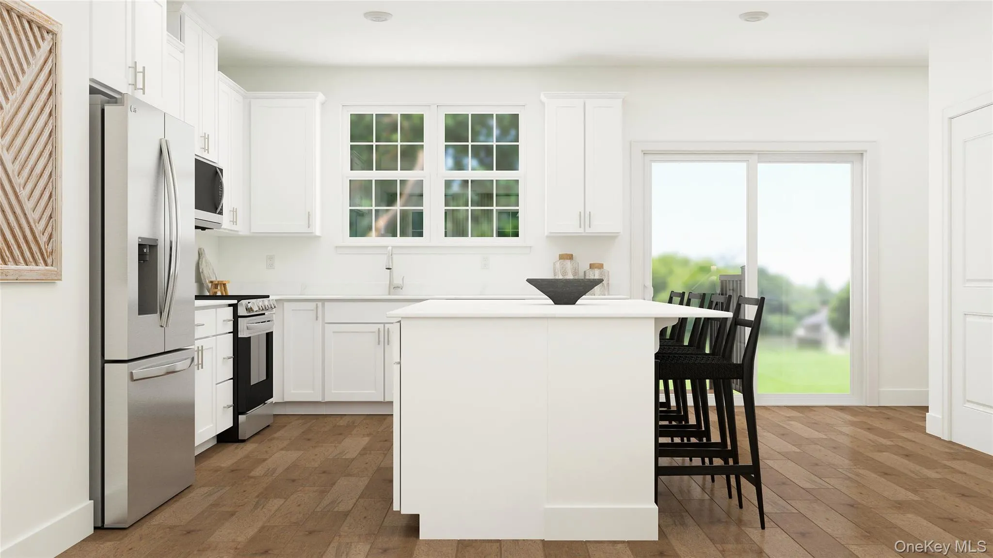 Kitchen with stainless steel appliances, a center island, a breakfast bar area, and white cabinetry Kitchen with stainless steel appliances, a center island, a breakfast bar area, and white cabinetry