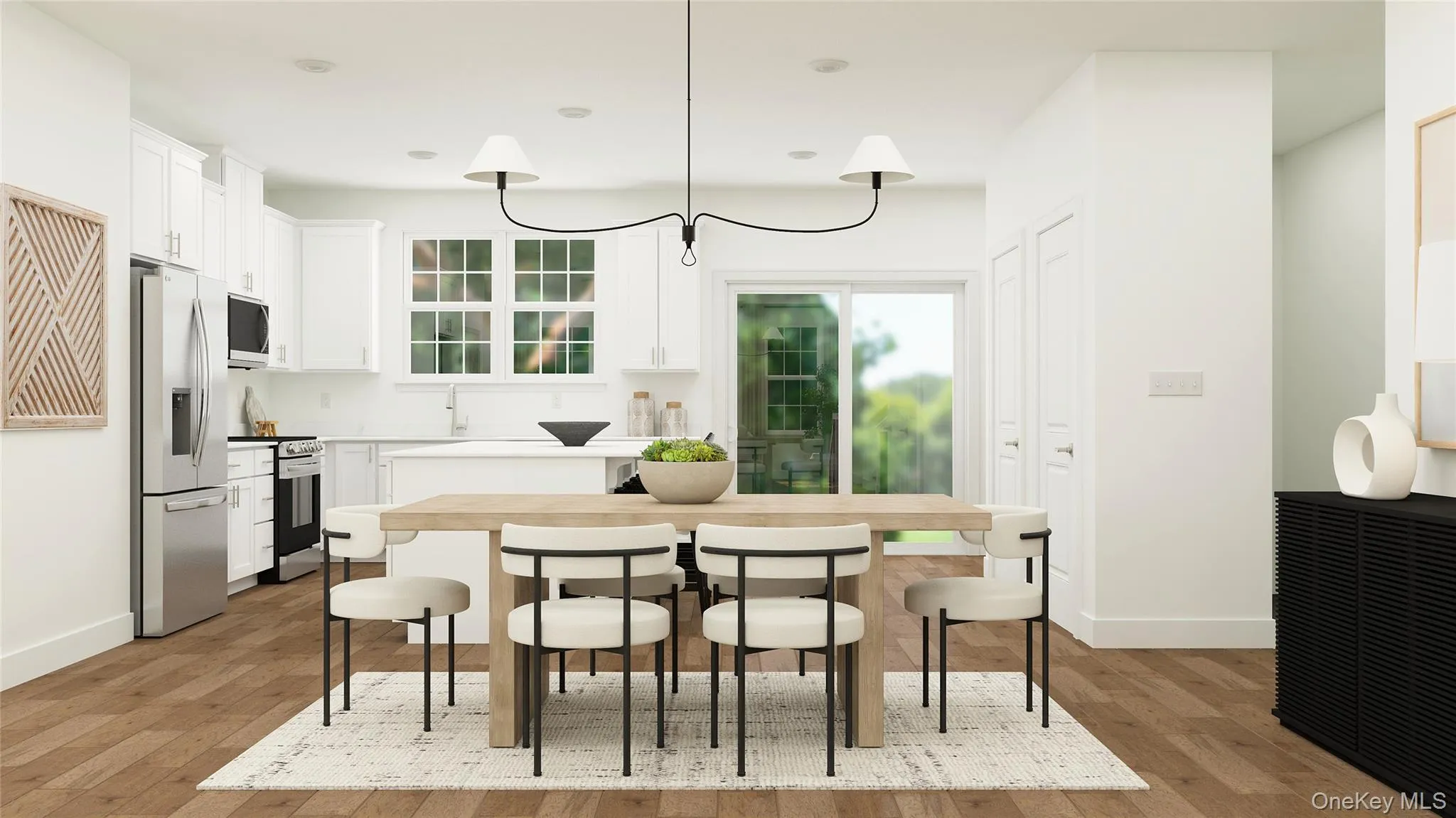 Kitchen featuring white cabinets, pendant lighting, appliances with stainless steel finishes, and a kitchen bar Kitchen featuring white cabinets, pendant lighting, appliances with stainless steel finishes, and a kitchen bar