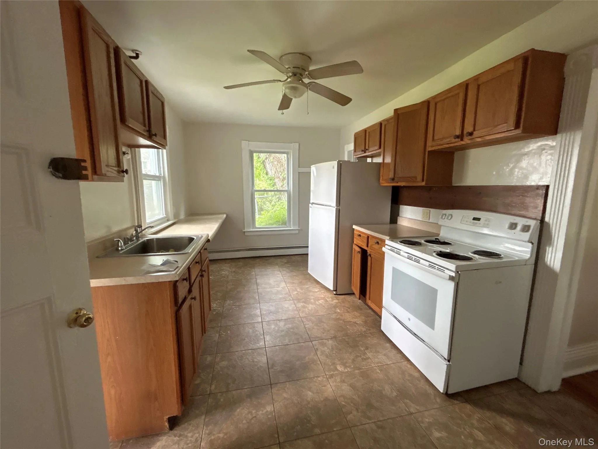Galley Kitchen with tile floor. There is a spacious mud room as you enter the kitchen Galley Kitchen with tile floor. There is a spacious mud room as you enter the kitchen