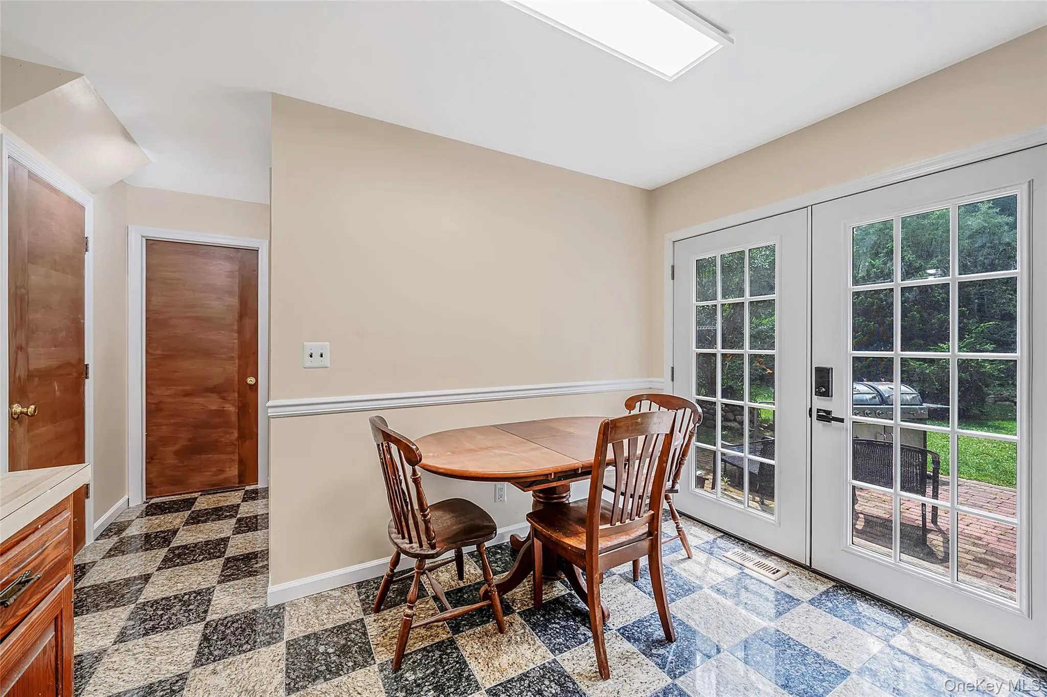 Kitchen area featuring checkerboard flooring and neutral wall tones Kitchen area featuring checkerboard flooring and neutral wall tones