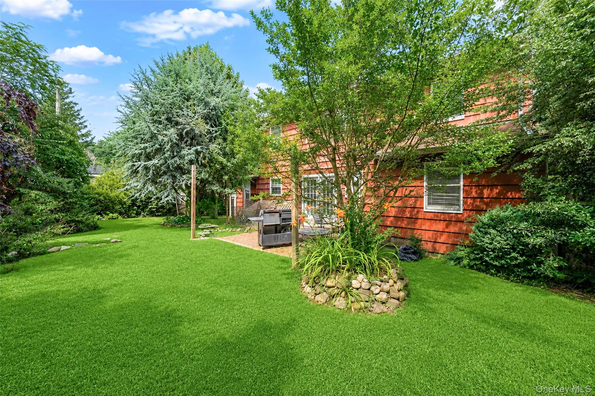 Expansive green lawn with mature trees and established landscaping Expansive green lawn with mature trees and established landscaping