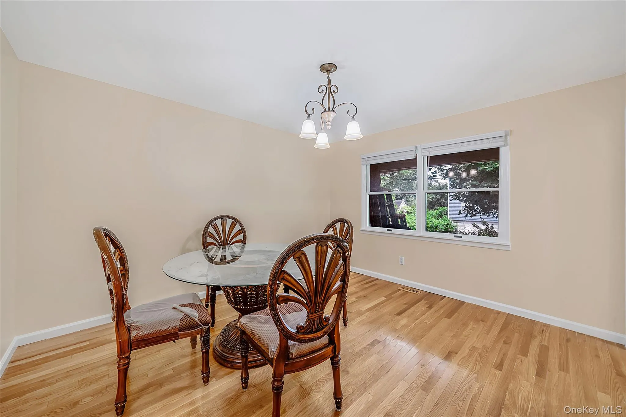 Light-toned wood flooring with a white baseboard Light-toned wood flooring with a white baseboard