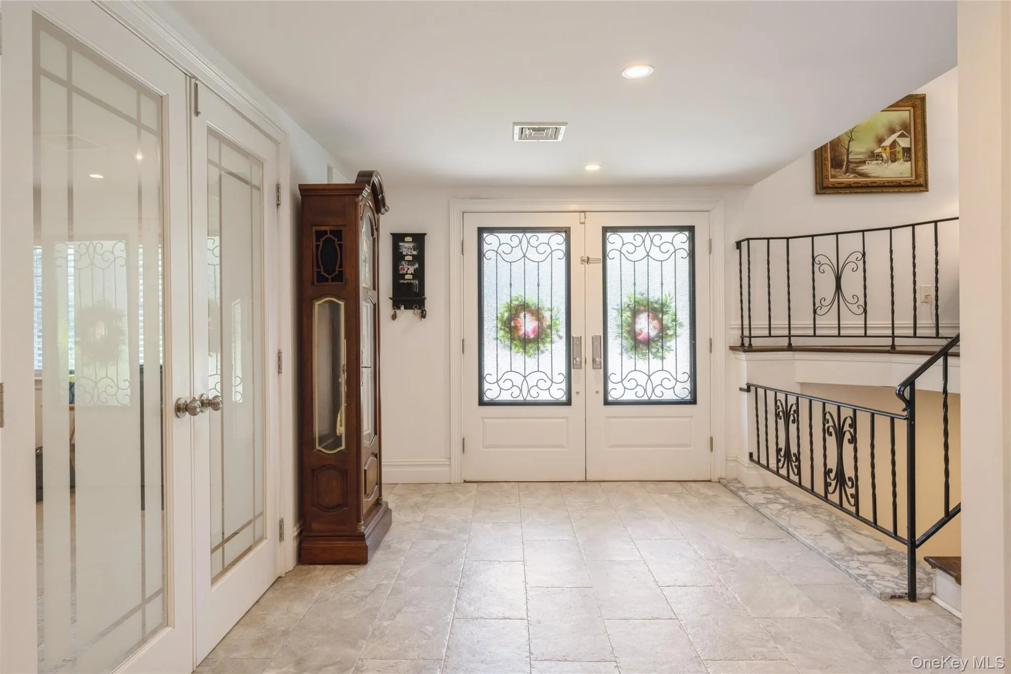 Entry leading to den, 5th bedroom, powder room, finished basement and main level Entry leading to den, 5th bedroom, powder room, finished basement and main level