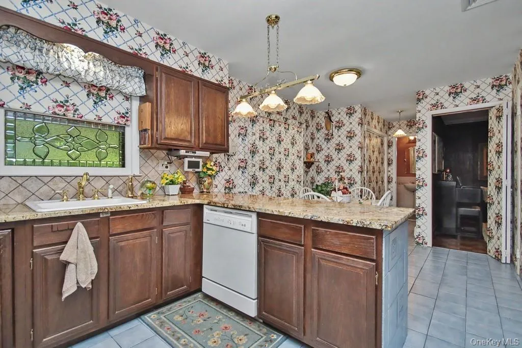 Kitchen has wood cabinetry Kitchen has wood cabinetry