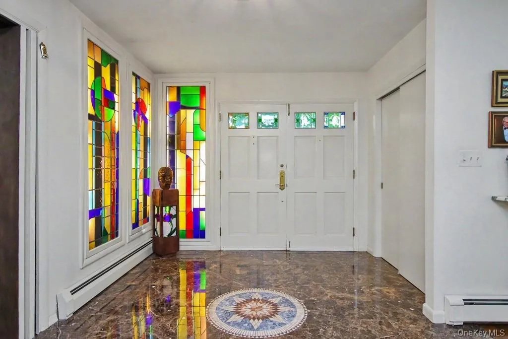 Entry way has stained glass panels and double closet Entry way has stained glass panels and double closet