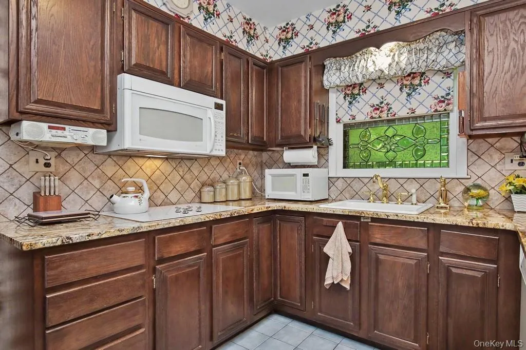 Kitchen has tumble marble backsplash Kitchen has tumble marble backsplash