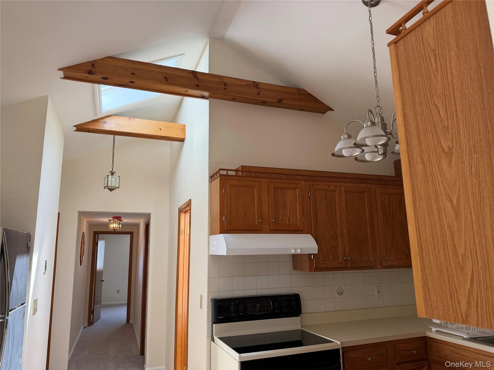 Vaulted ceilings w/ exposed wood beams and skylights complement the adjacent kitchen space. Vaulted ceilings w/ exposed wood beams and skylights complement the adjacent kitchen space.