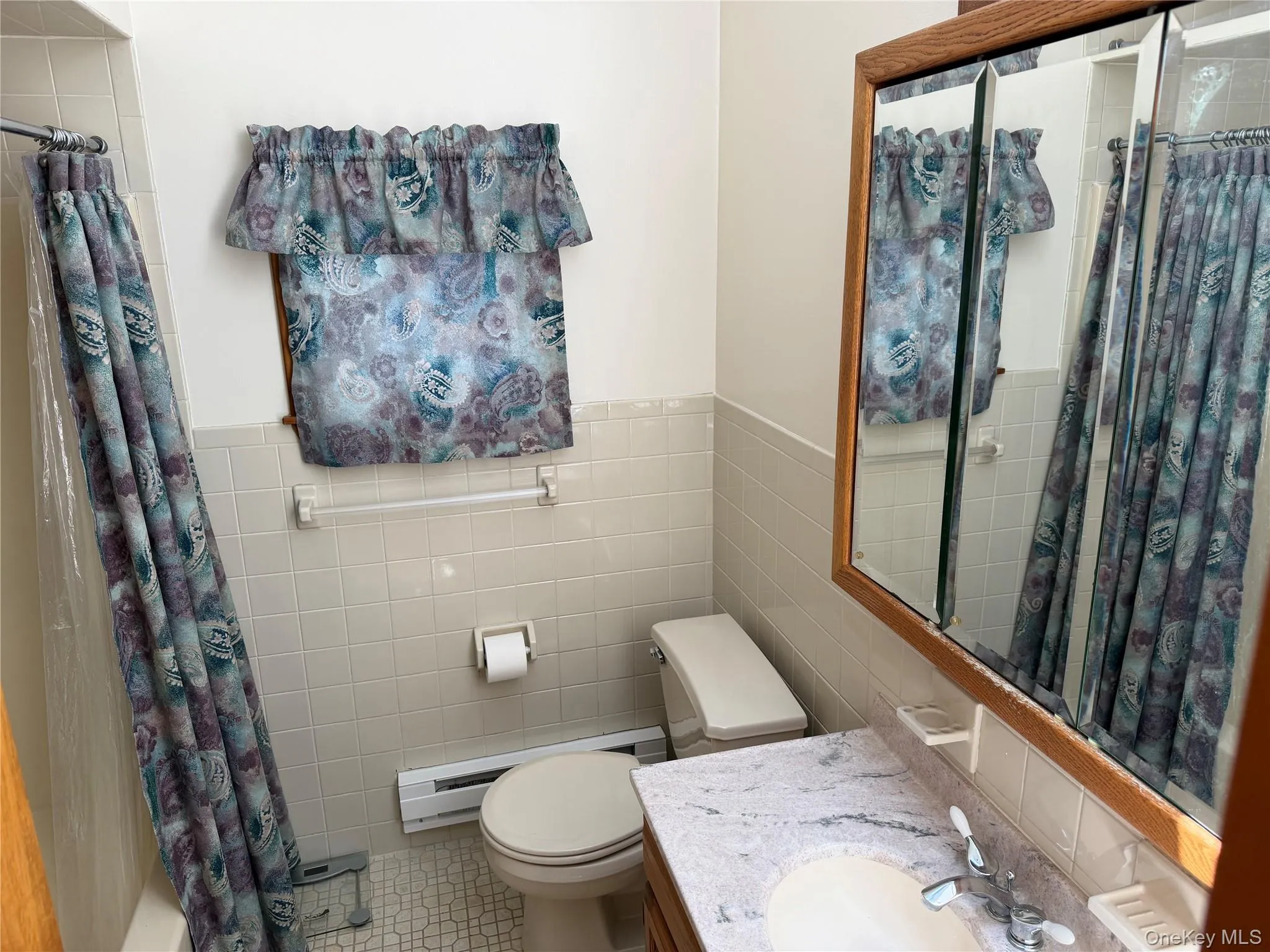 Bathroom featuring, tiled floor and walls, mirrored wall cabinet,& vanity Bathroom featuring, tiled floor and walls, mirrored wall cabinet,& vanity