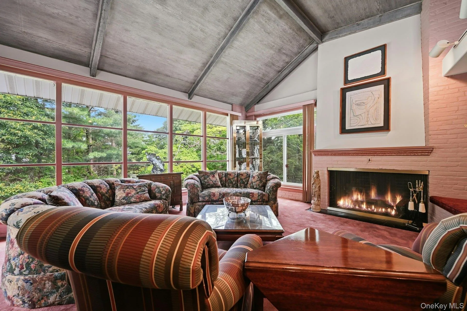 Spacious Great Room with Cathedral Ceilings, Oversized Fireplace, Walls of Glass, and Built in Bar Spacious Great Room with Cathedral Ceilings, Oversized Fireplace, Walls of Glass, and Built in Bar