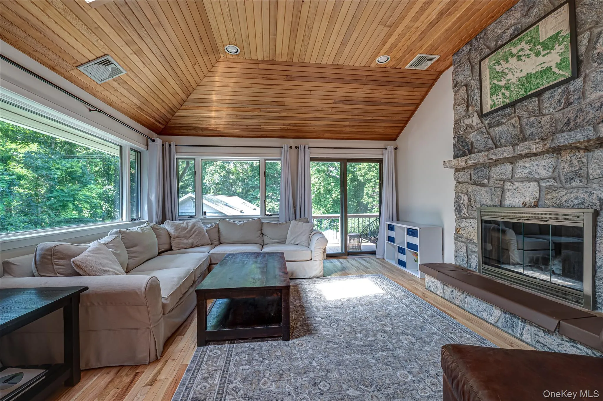 Living Room with Vaulted Ceilings, Natural Wood Floors and plenty of windows Living Room with Vaulted Ceilings, Natural Wood Floors and plenty of windows