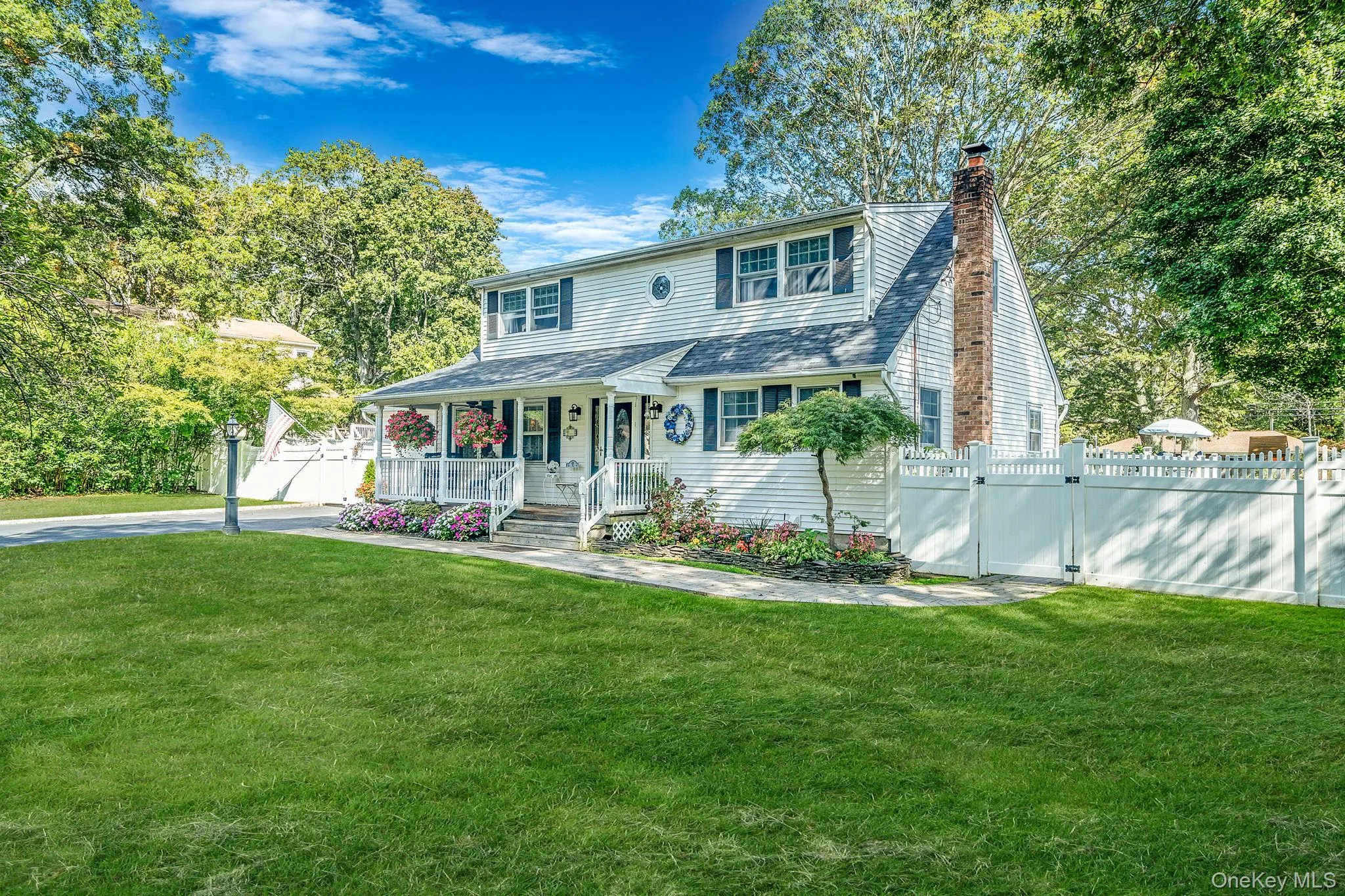 Two-story residence featuring white siding and a dark shingle roof Two-story residence featuring white siding and a dark shingle roof