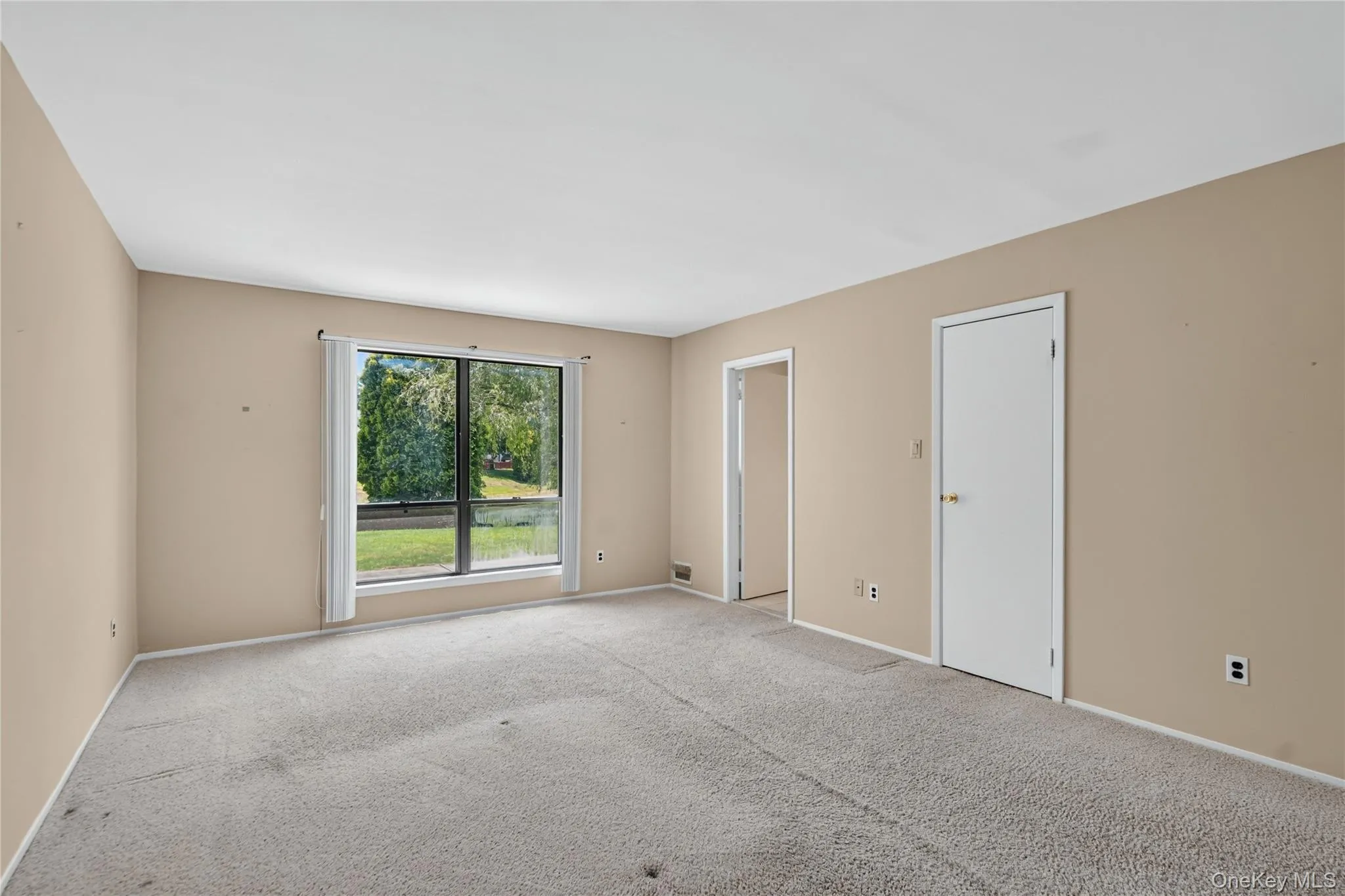 Primary in back of condo with views of calming pond Primary in back of condo with views of calming pond