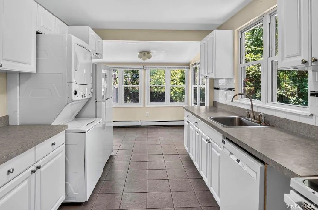 Kitchen featuring stackable W/D. Kitchen featuring stackable W/D.