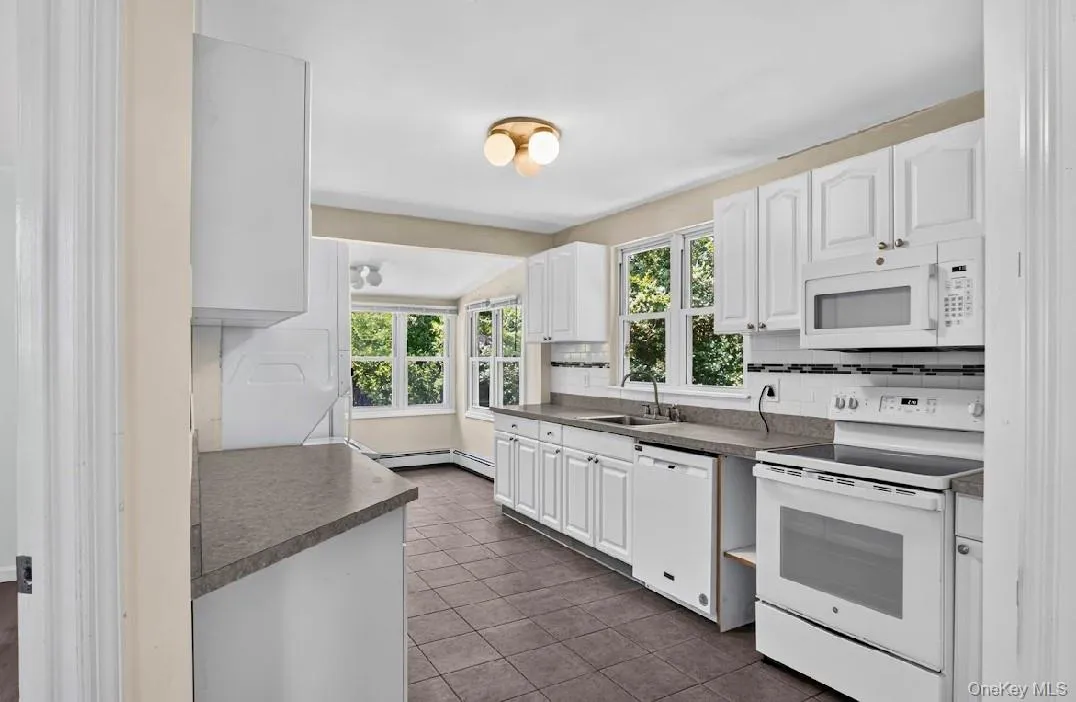 Kitchen featuring stove, microwave, dishwasher. Kitchen featuring stove, microwave, dishwasher.