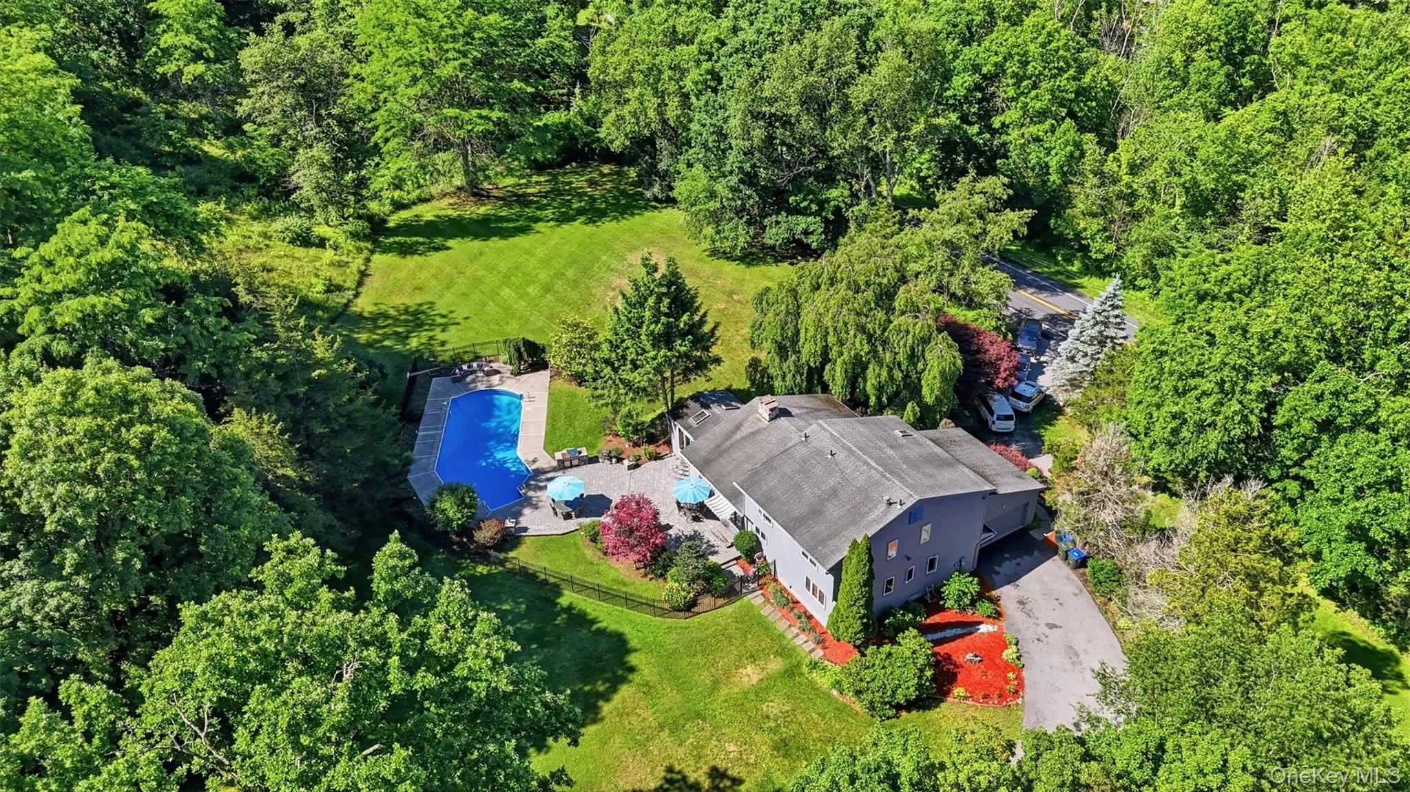 Expansive property featuring a large residence, private swimming pool, paved driveway, mature trees, and landscaped grounds Expansive property featuring a large residence, private swimming pool, paved driveway, mature trees, and landscaped grounds