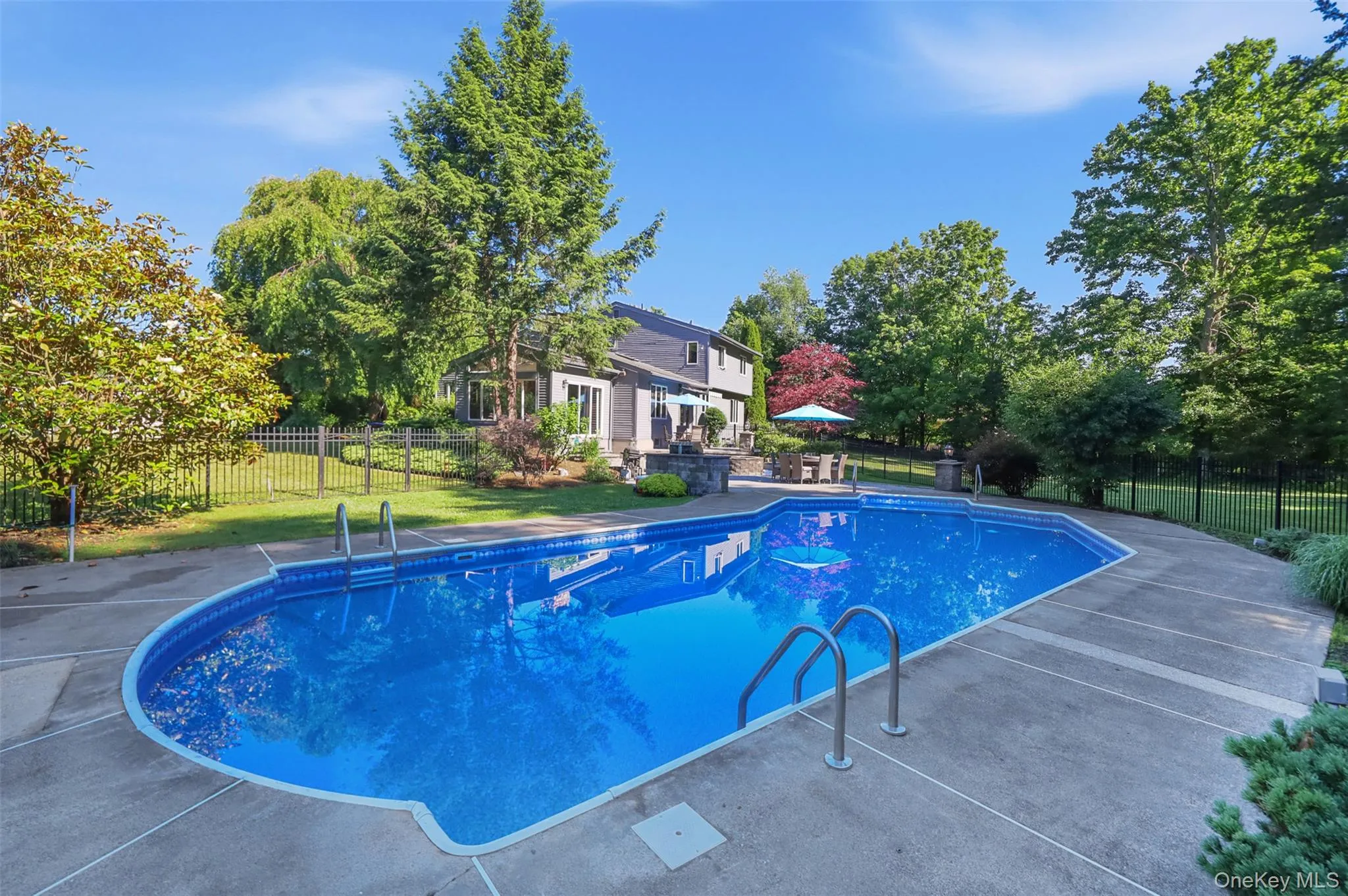 In-ground swimming pool with concrete surround In-ground swimming pool with concrete surround