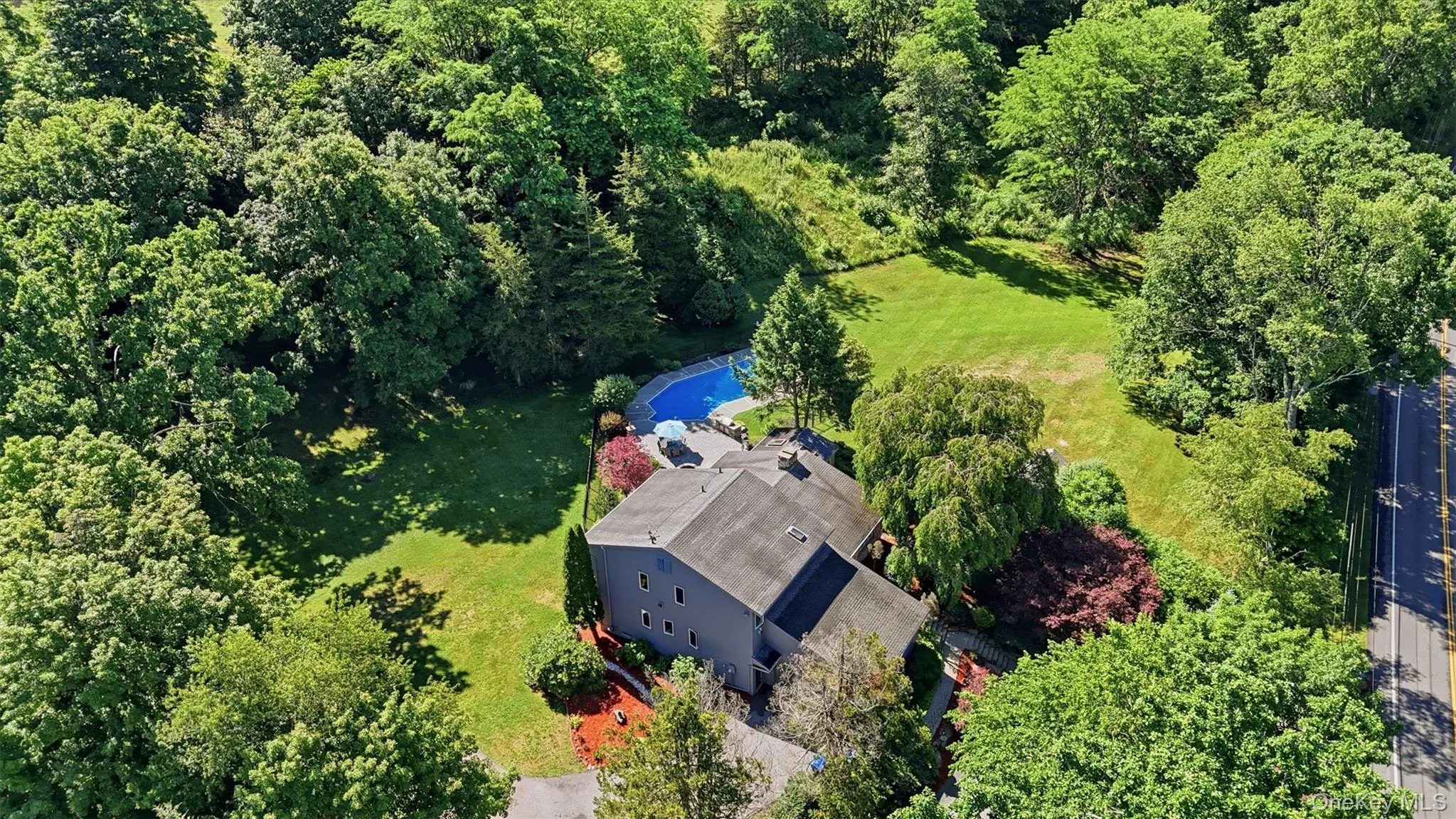 Multi-level residence with an inground pool and surrounding patio Multi-level residence with an inground pool and surrounding patio
