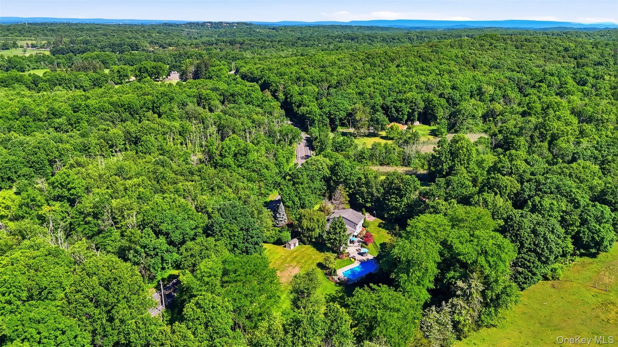 Aerial overview of a private residential property amidst extensive tree coverage Aerial overview of a private residential property amidst extensive tree coverage