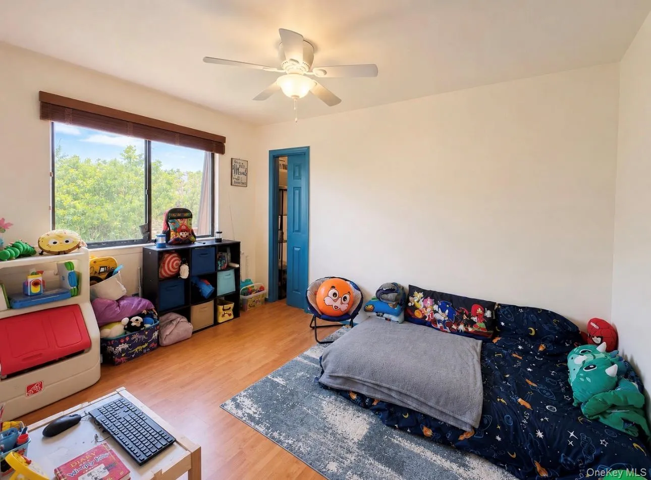 Interior room featuring wood-finish flooring and a pocket door Interior room featuring wood-finish flooring and a pocket door