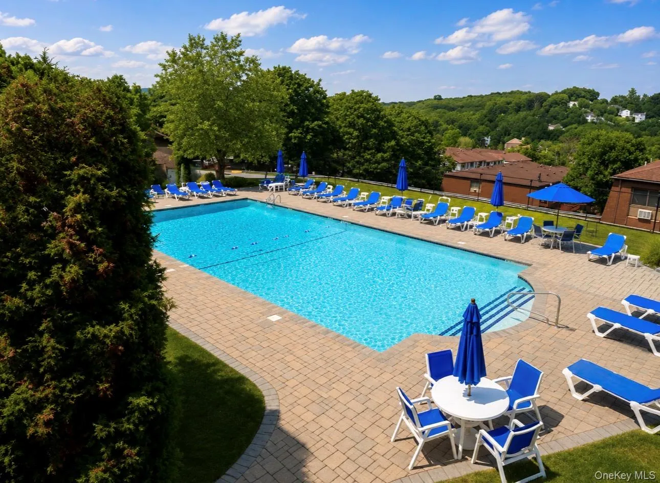 Outdoor swimming pool with integrated steps, surrounded by a paver deck Outdoor swimming pool with integrated steps, surrounded by a paver deck