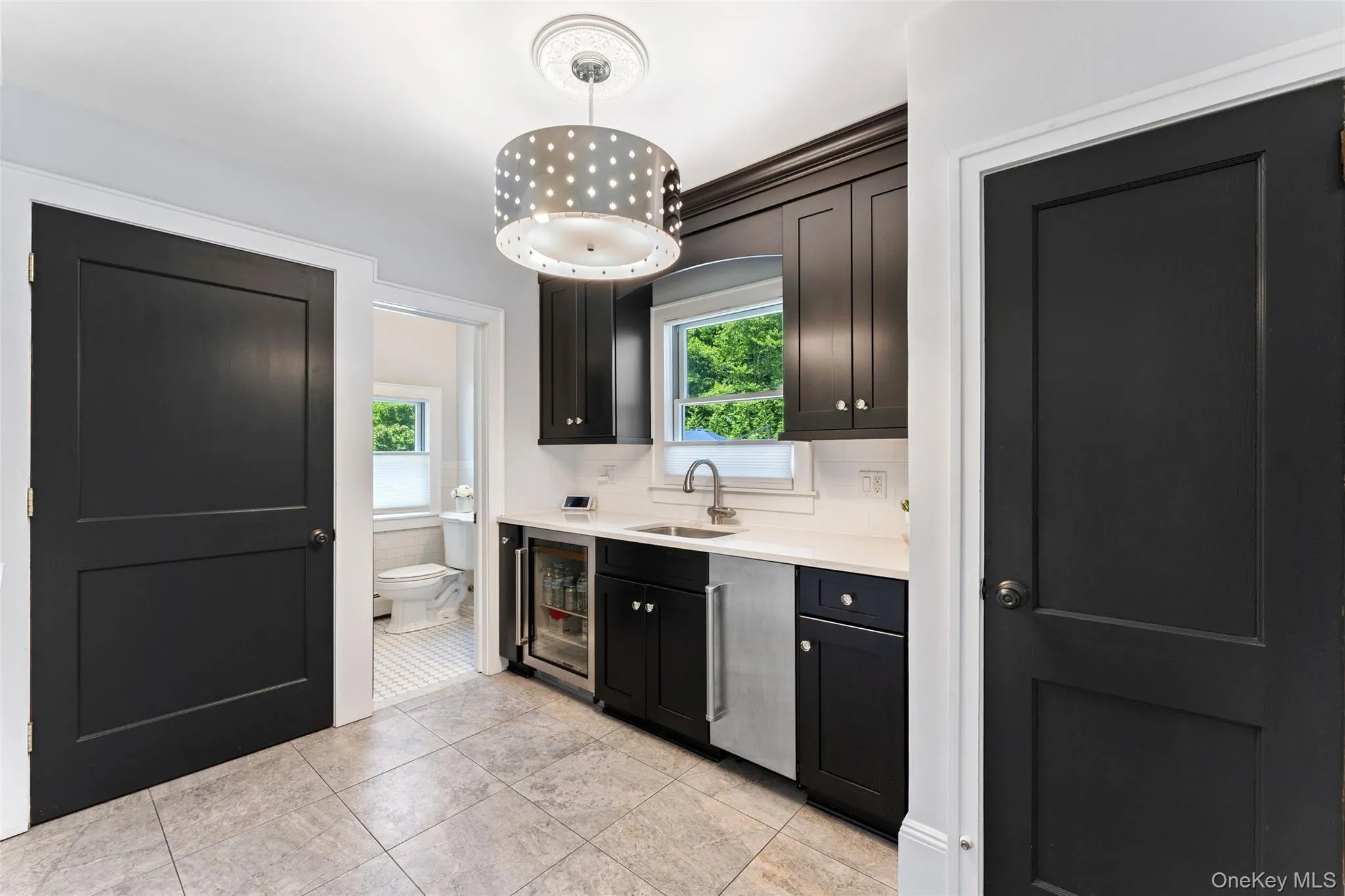 Butlers Pantry featuring a Sub Zero ice maker, beverage refrigerator, abundant storage and laundry. Butlers Pantry featuring a Sub Zero ice maker, beverage refrigerator, abundant storage and laundry.