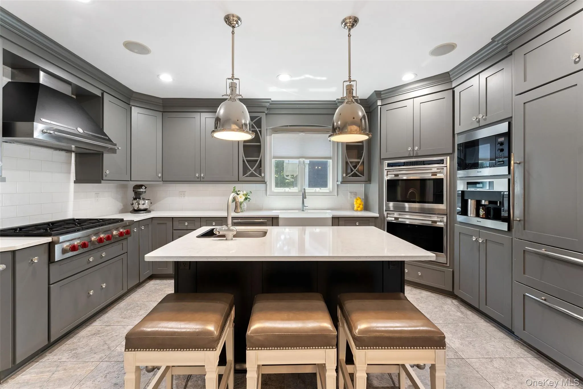 Chef's kitchen featuring a Wolf double oven, Wolf 6-burner stove and Miele built in coffee system w grinder. Chef's kitchen featuring a Wolf double oven, Wolf 6-burner stove and Miele built in coffee system w grinder.