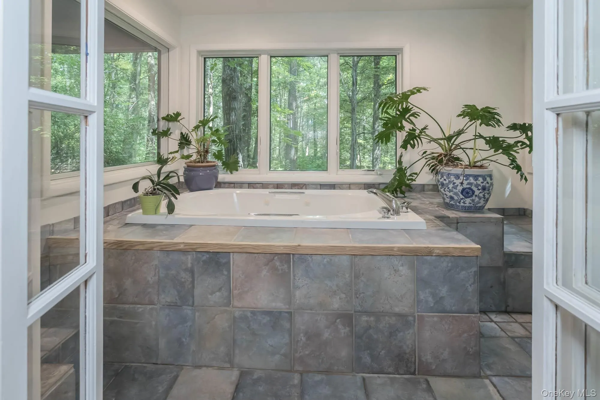 Separate room with Jacuzzi and walls of windows Separate room with Jacuzzi and walls of windows