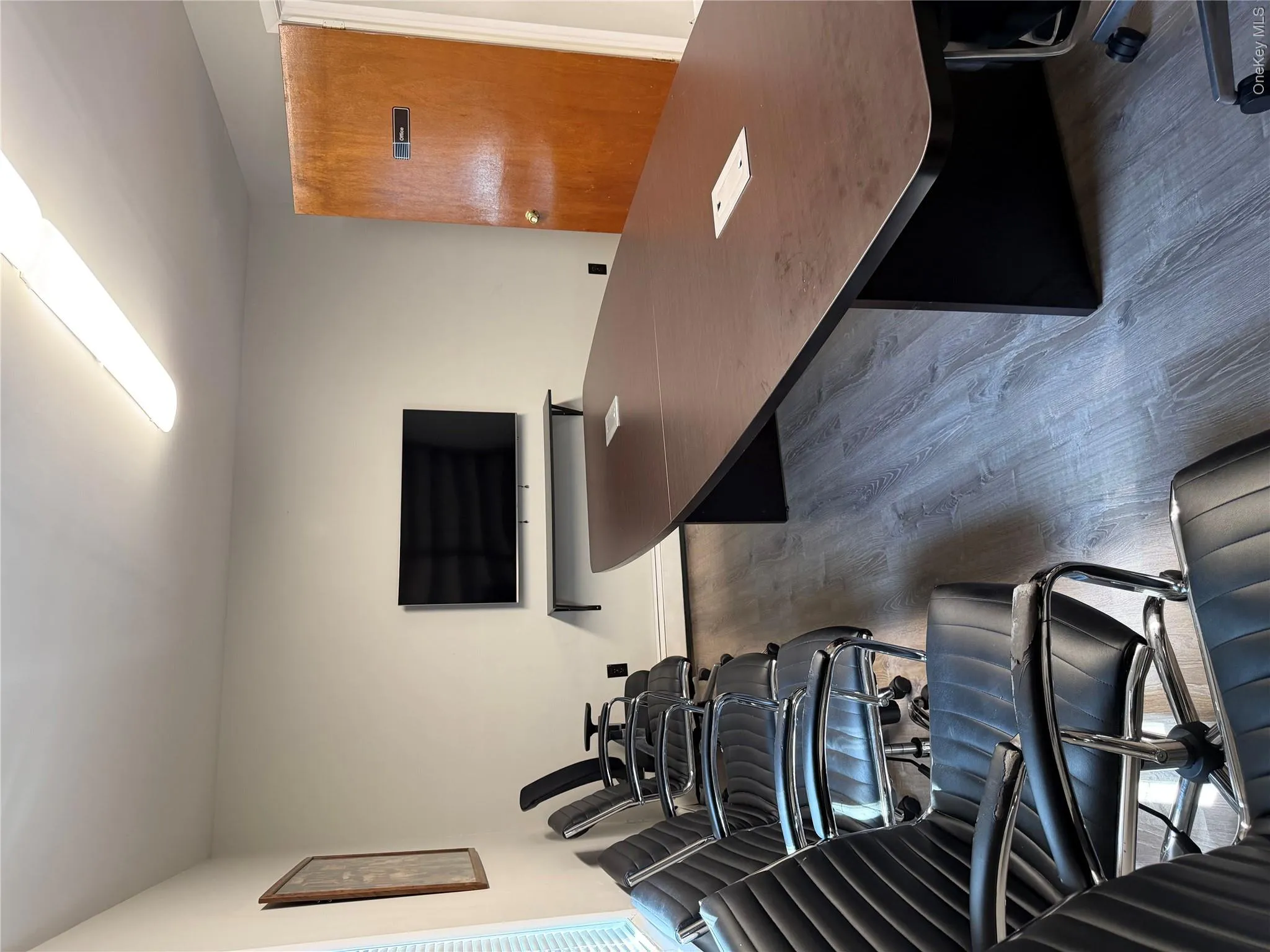Private executive office with wood-finish flooring Private executive office with wood-finish flooring