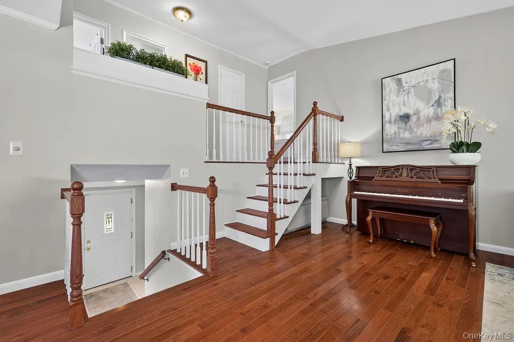 another view of living room with hardwood flooring another view of living room with hardwood flooring