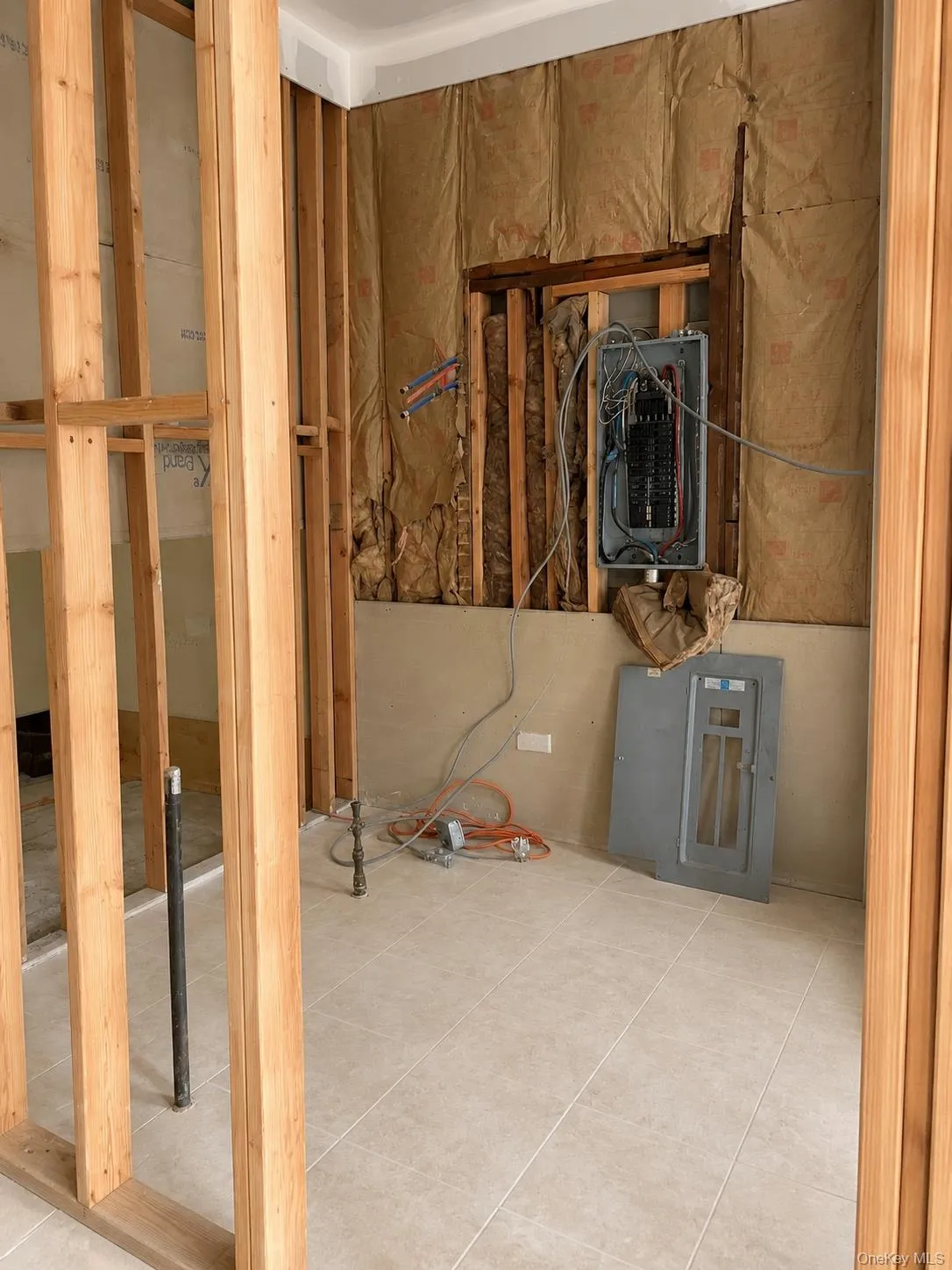 Interior with framing and tile floor. Electrical Box and Pipe Interior with framing and tile floor. Electrical Box and Pipe