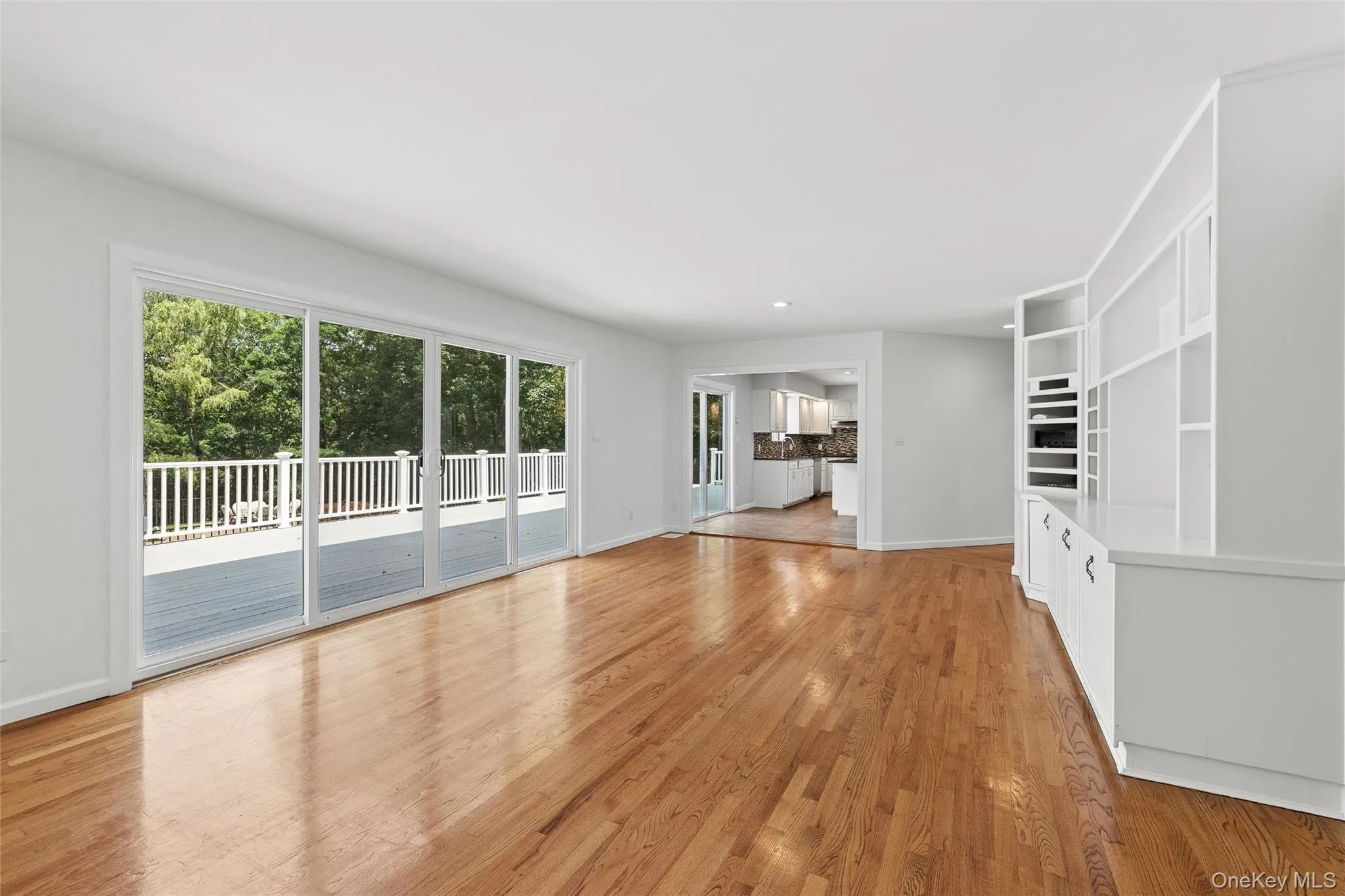 Family room leading into large eat in kitchen. Sliding doors to deck. Family room leading into large eat in kitchen. Sliding doors to deck.