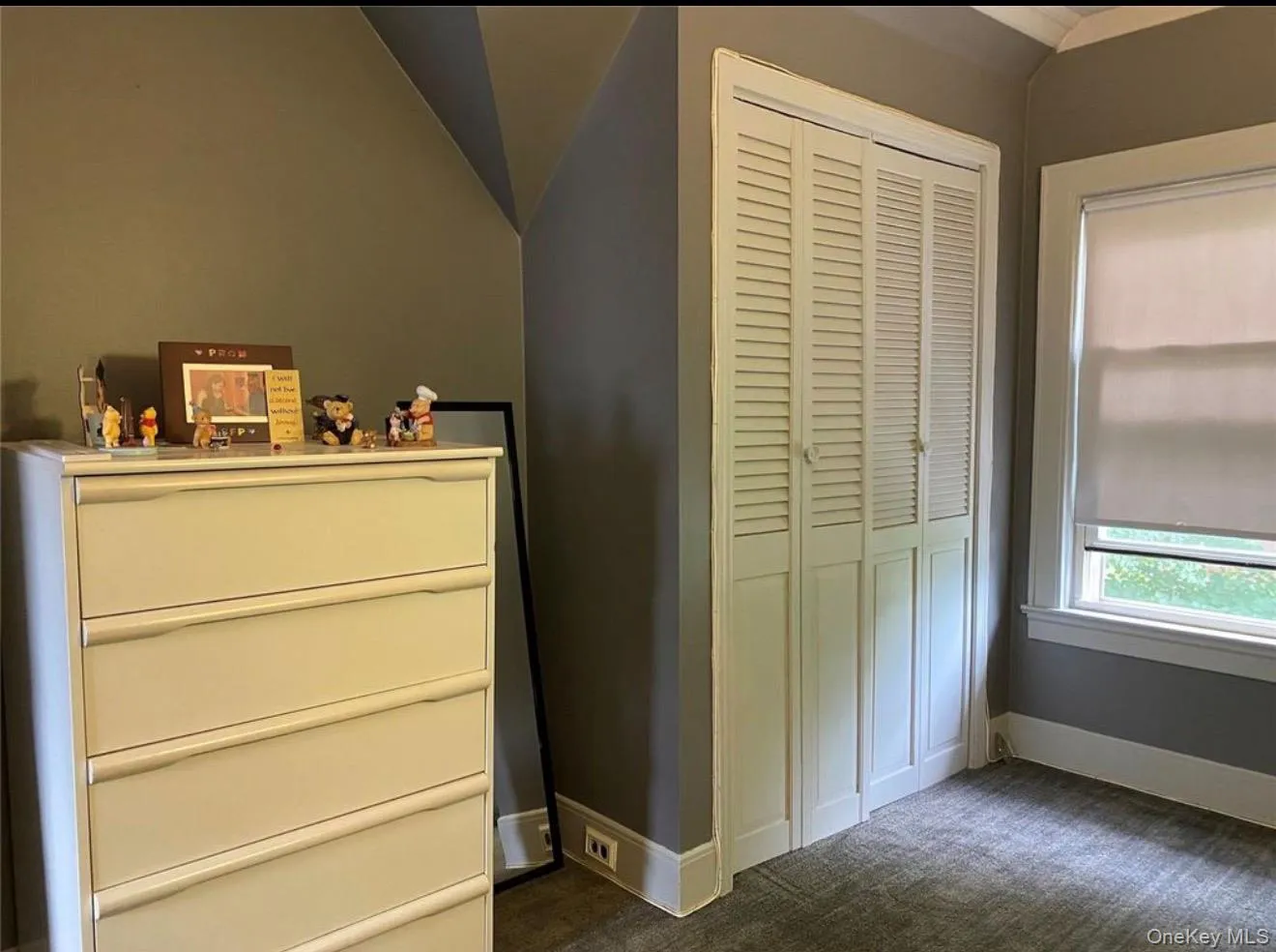 Built-in louvered bi-fold closet doors with white trim and baseboards Built-in louvered bi-fold closet doors with white trim and baseboards