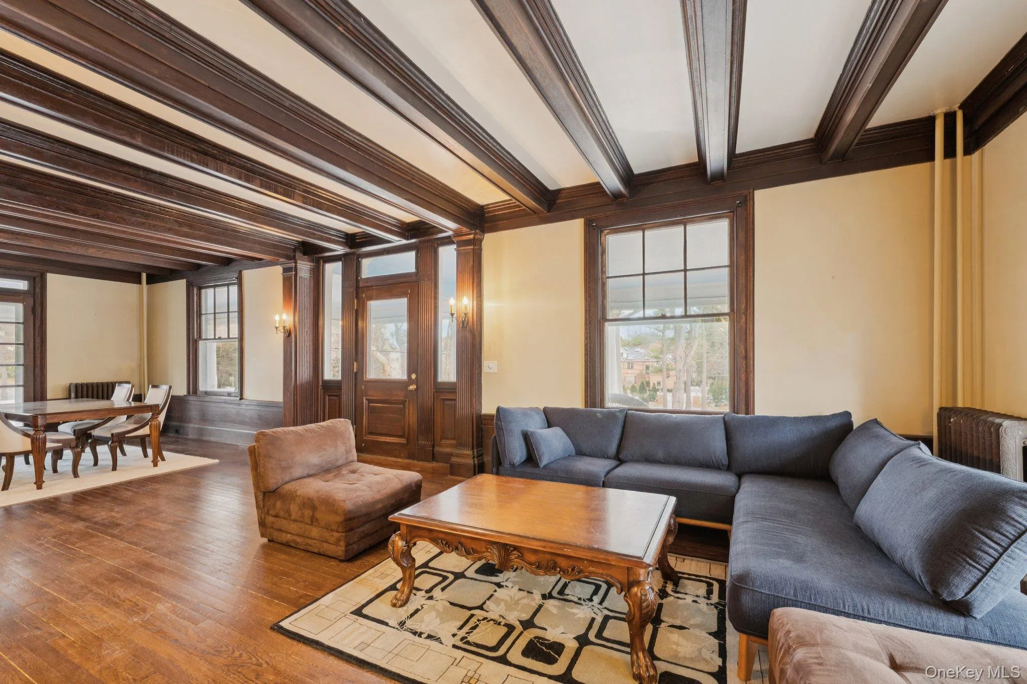 Living room with beam ceiling, hardwood / wood-style flooring, and crown molding Living room with beam ceiling, hardwood / wood-style flooring, and crown molding