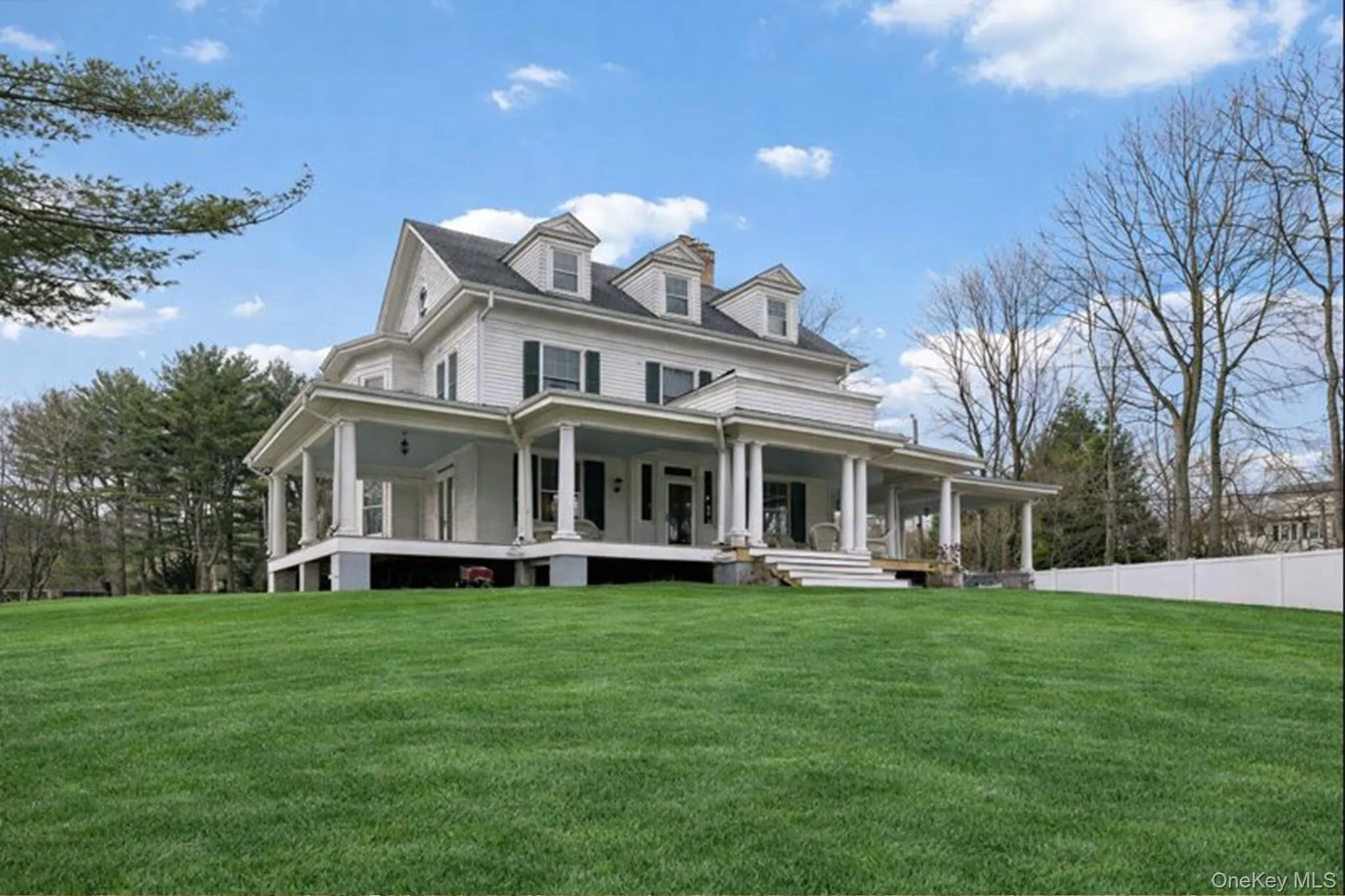 Farmhouse inspired home with a porch and a front lawn Farmhouse inspired home with a porch and a front lawn