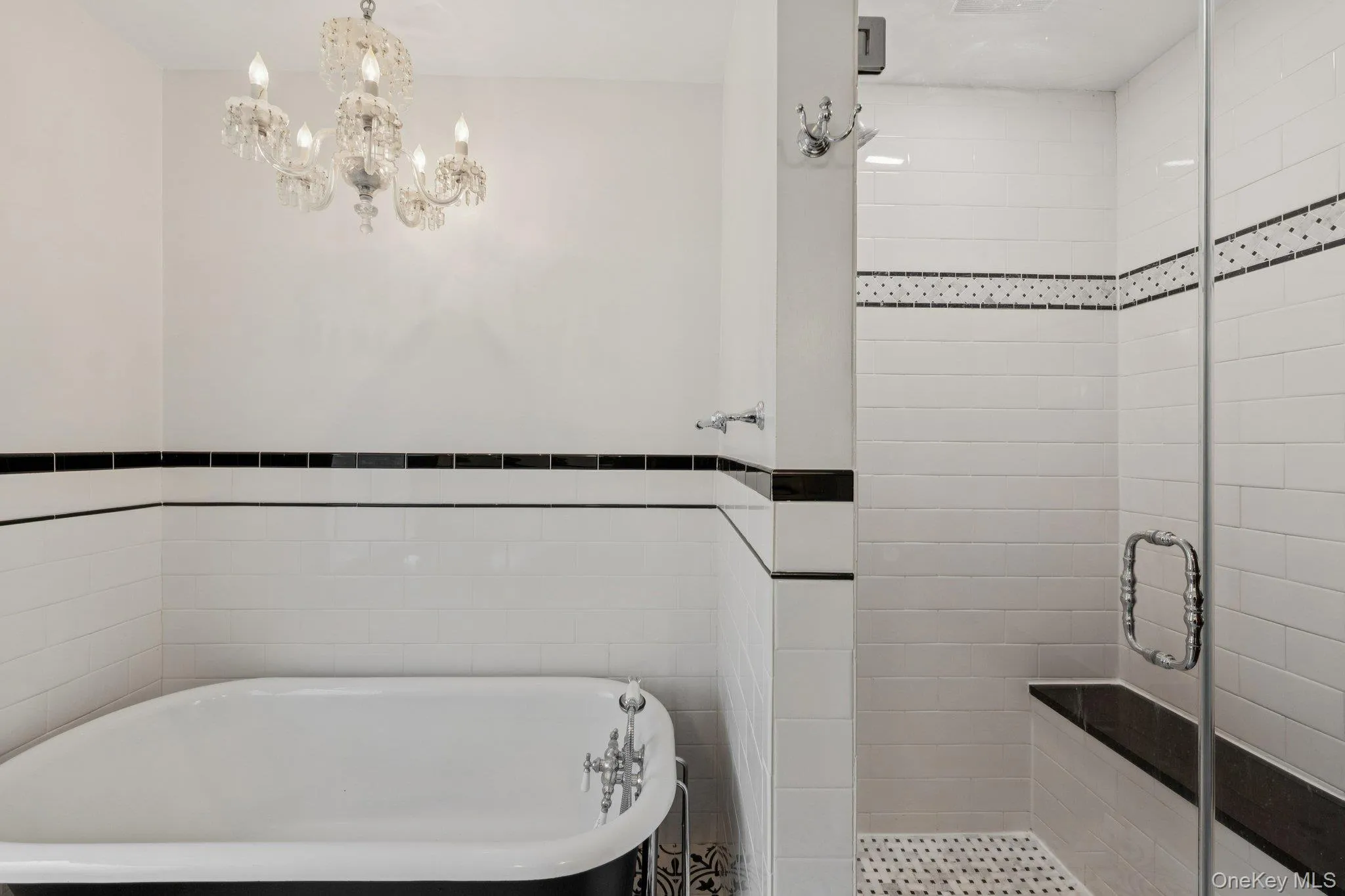 Bathroom featuring a freestanding bath, a stall shower, and tile walls Bathroom featuring a freestanding bath, a stall shower, and tile walls